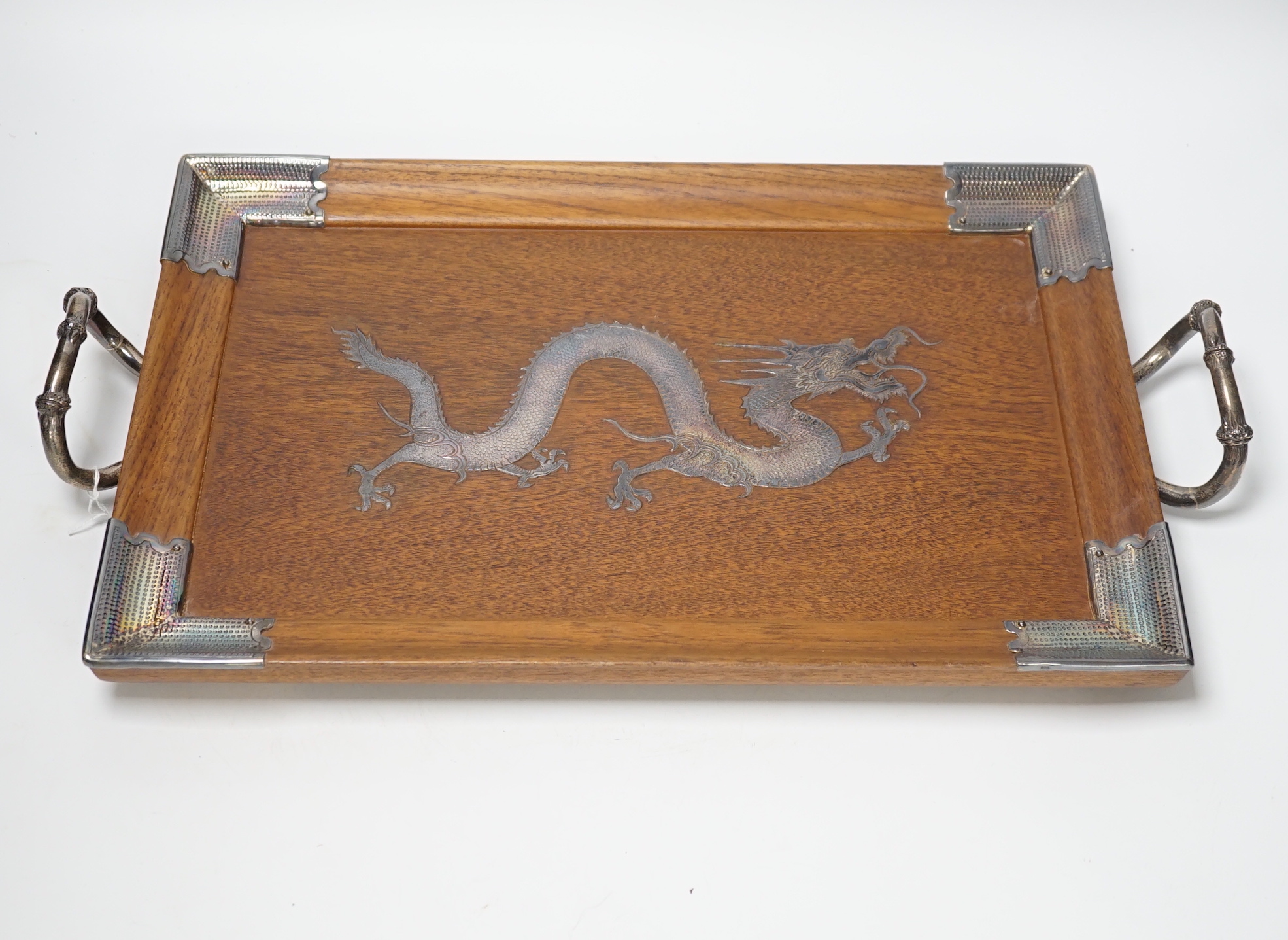 A Japanese white metal inlaid ‘dragon’ tray with bamboo style handles, 49cm wide